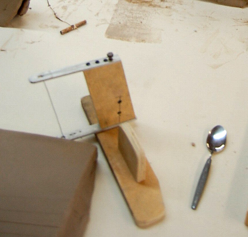 of cutting jig. The bolt at the top right is similar to a guitar 